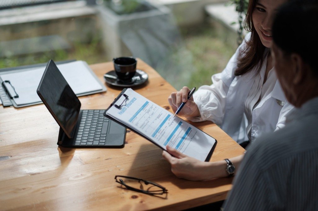 Consultant reviewing official documentation with a client